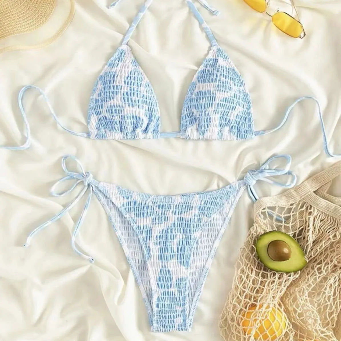 Women's floral halter neck two-piece swimsuit in light blue on a mannequin.