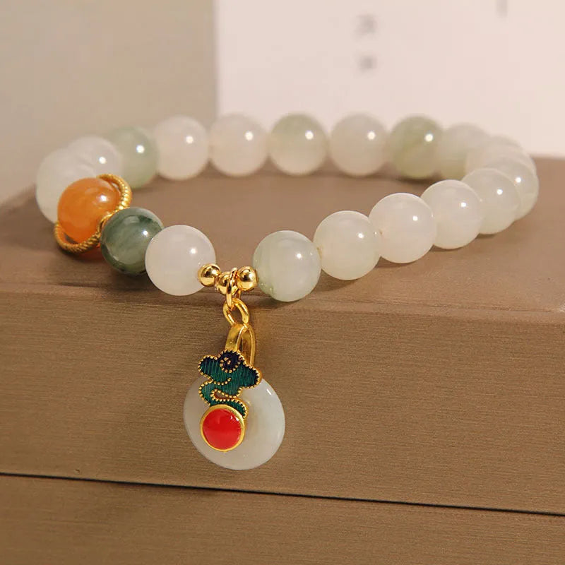 Women's ice jade crystal bracelet with a pearl detail and traditional Chinese jade buckle.