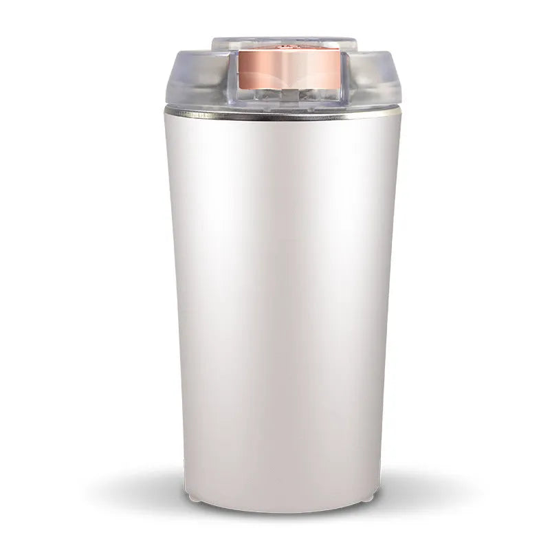 Blue mini electric flour mill and spice grinder with stainless steel grinding chamber.