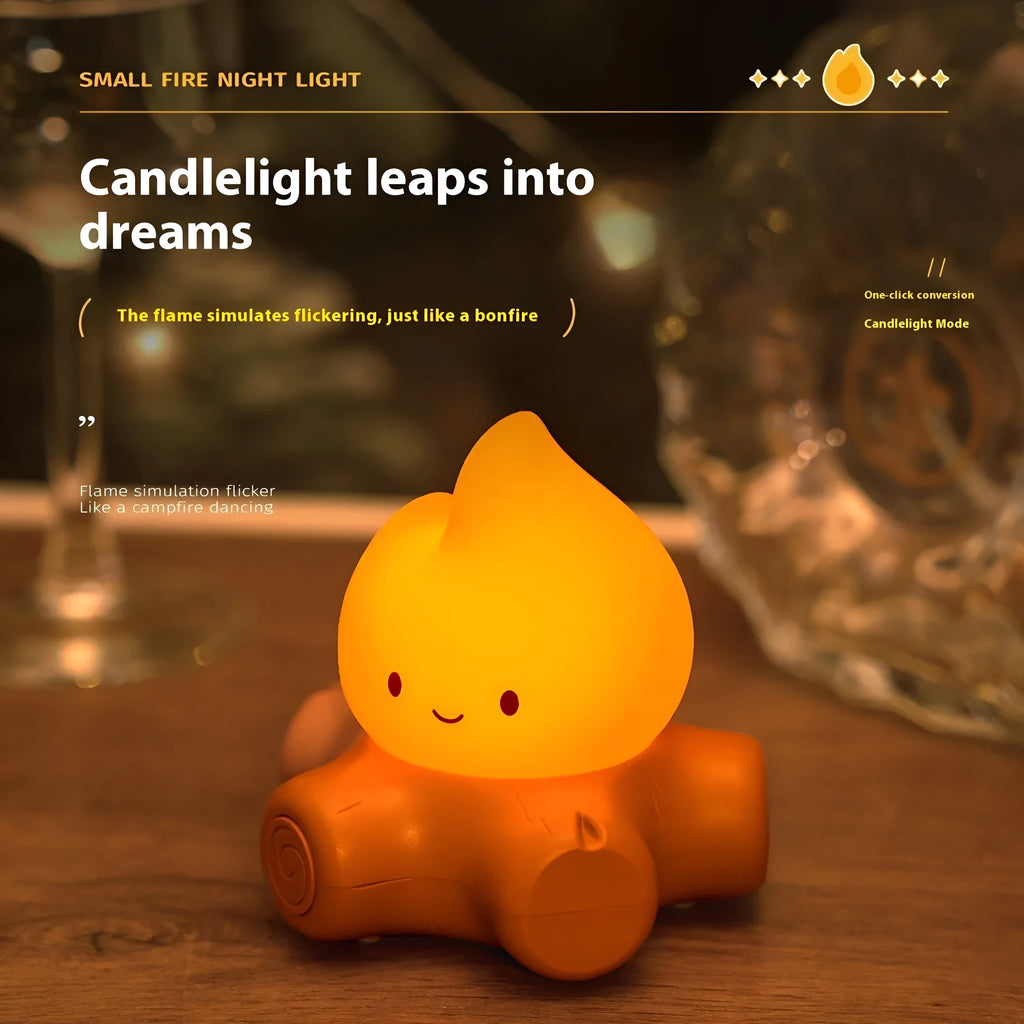 Small cartoon silicone fire pile night light with yellow LED glow and ABS shade on wooden surface.