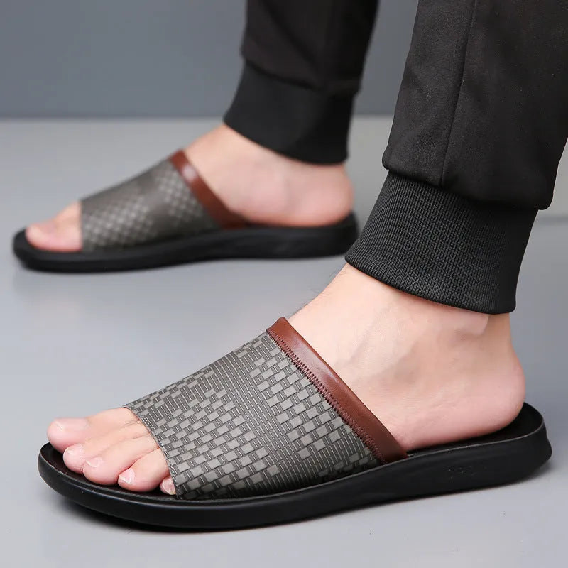 Men's breathable PU leather slippers in black with flat heel and round toe, side view