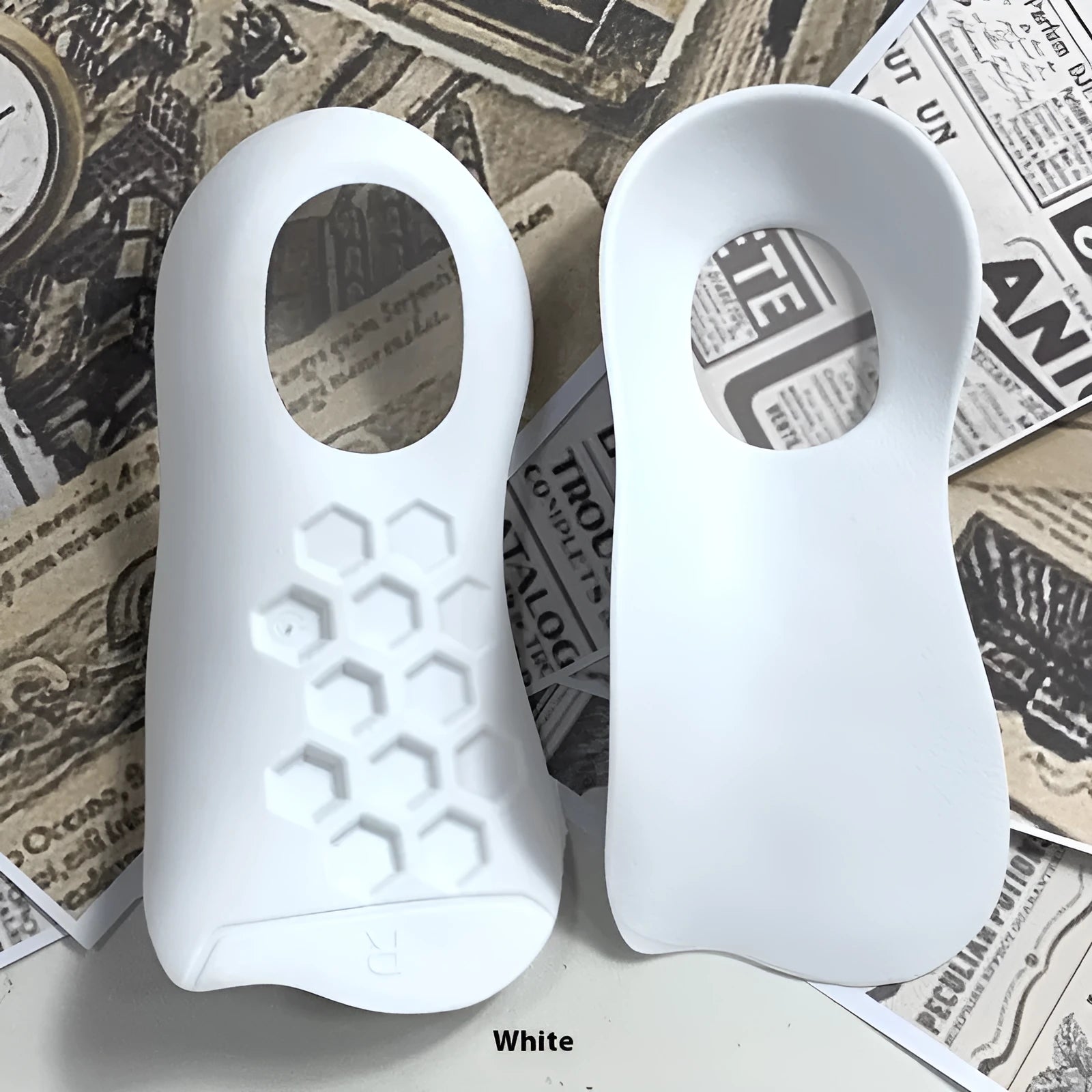 TPR varus correction arch support insoles in white, black and skin colours showing arch design