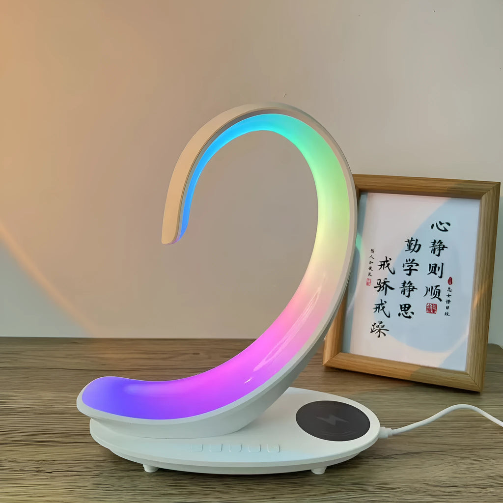 White swan shaped desk lamp with wireless charging pad and Bluetooth speaker featuring multi-colour lighting