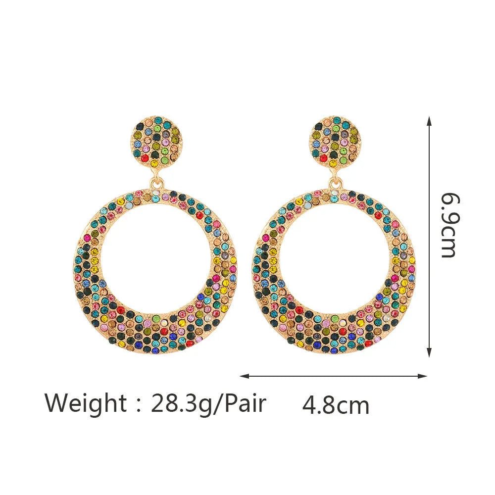Colourful alloy metal earrings with large round diamond-look pendants in cartoon style