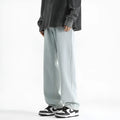 Men's light blue straight leg cotton jeans with button waist closure laid flat