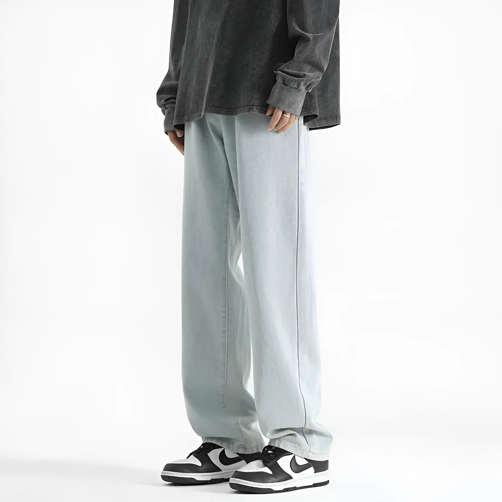 Men's light blue straight leg cotton jeans with button waist closure laid flat