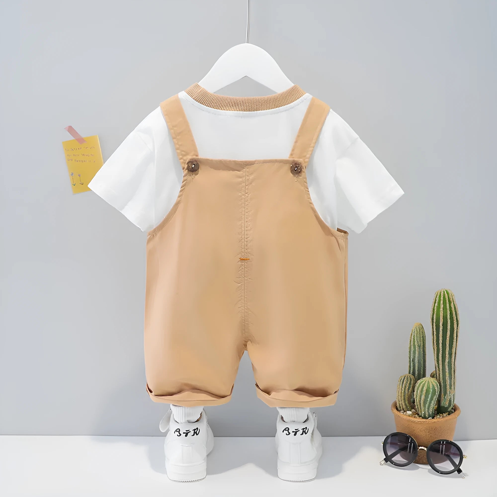 Yellow children's cotton overalls with cartoon design and detachable straps