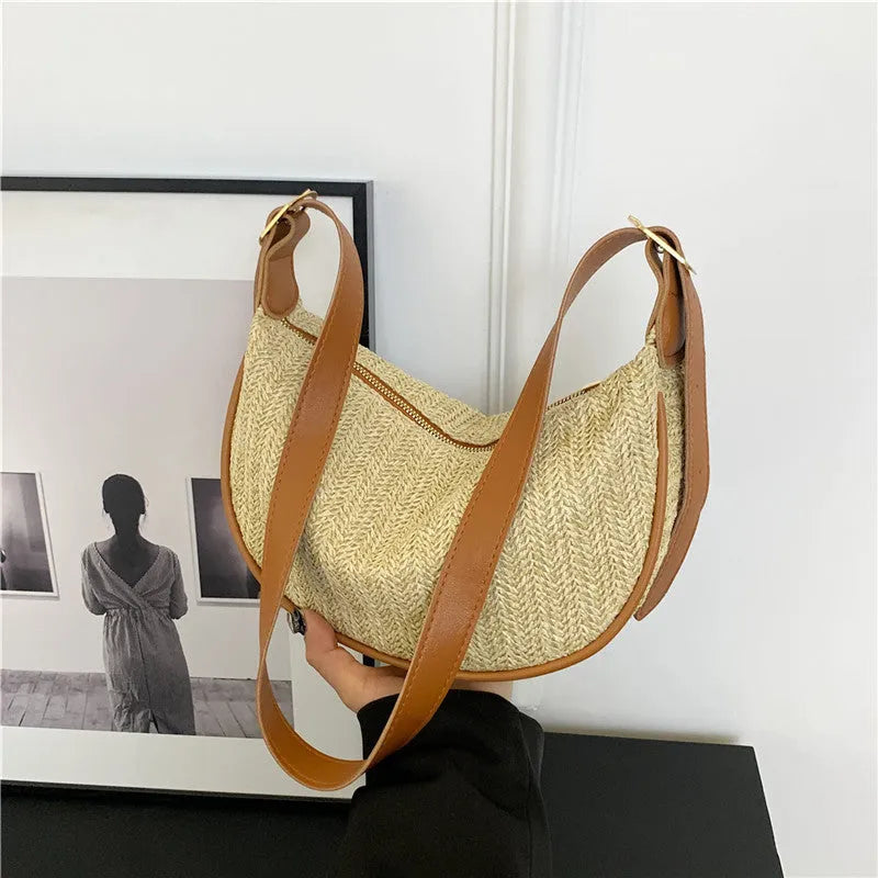Women's woven straw crossbody bag showing internal phone compartment and file pocket in milky white colour