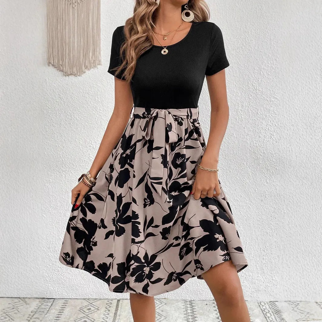Khaki floral print women's dress with lace-up detail and A-line skirt on a hanger