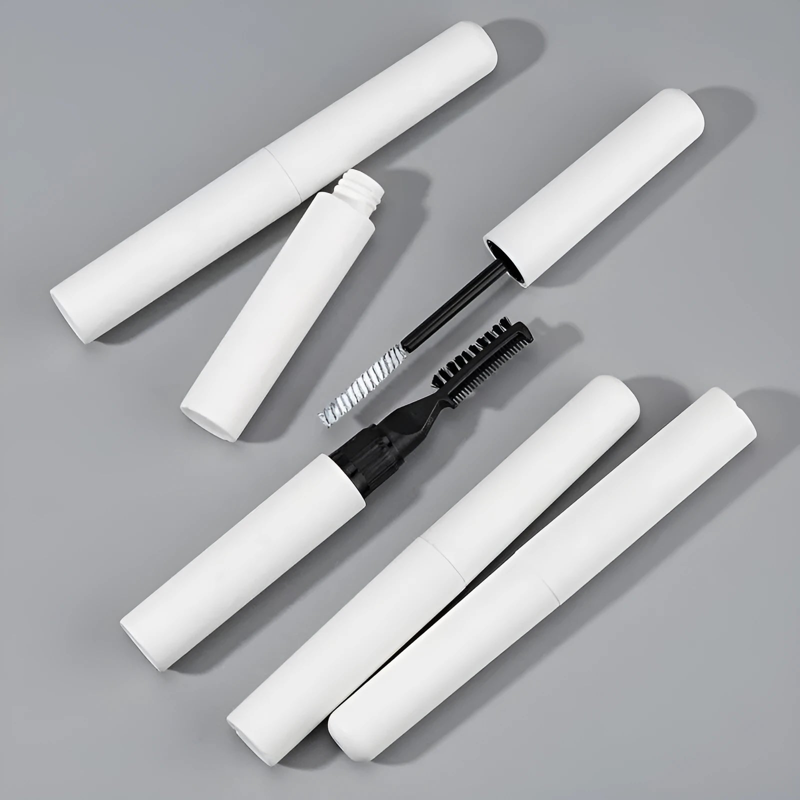 Brush applicator of pink and white eyebrow shaping gel for natural, long-lasting brows.