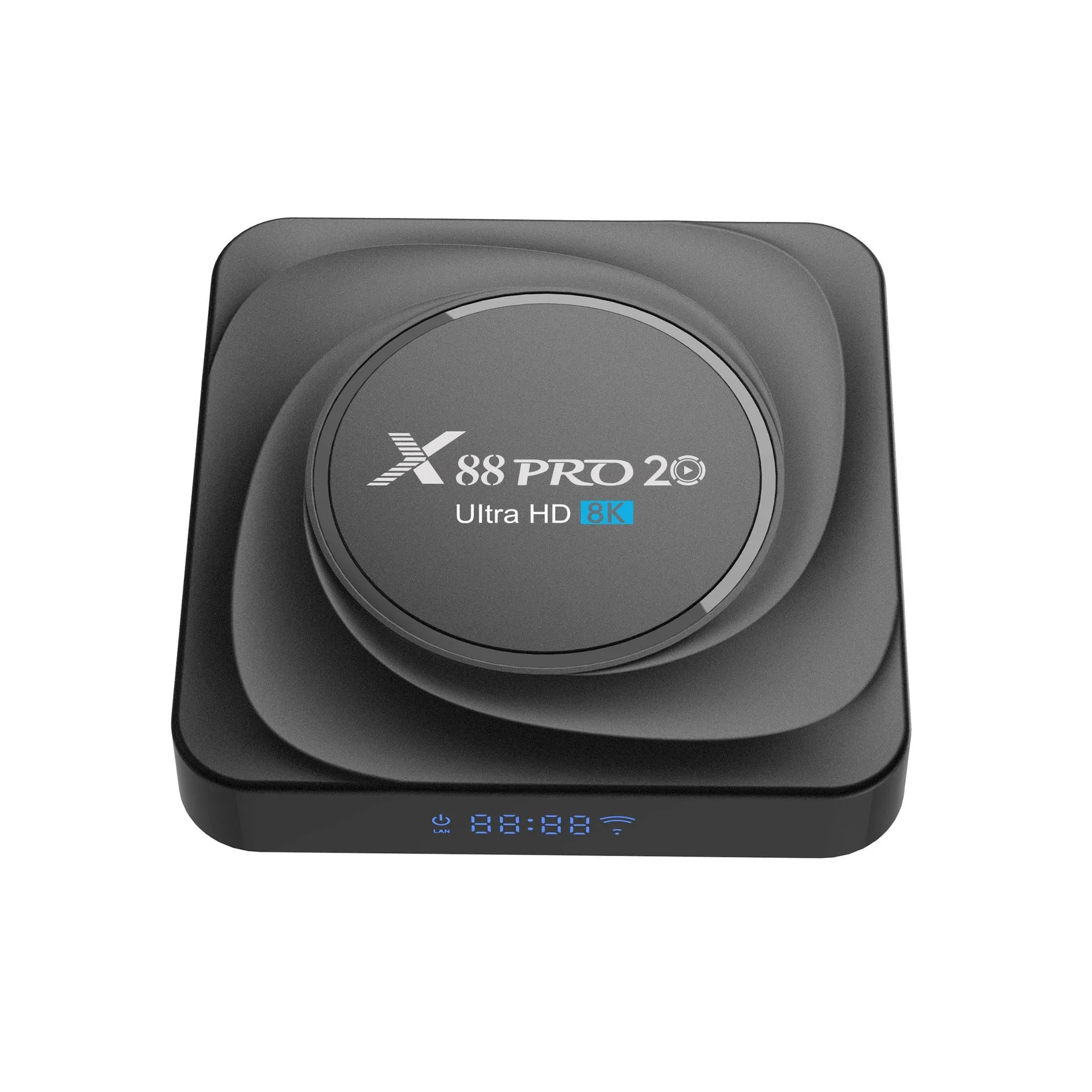 Compact black Android TV set-top box with remote control and HDMI cable on a wooden surface.