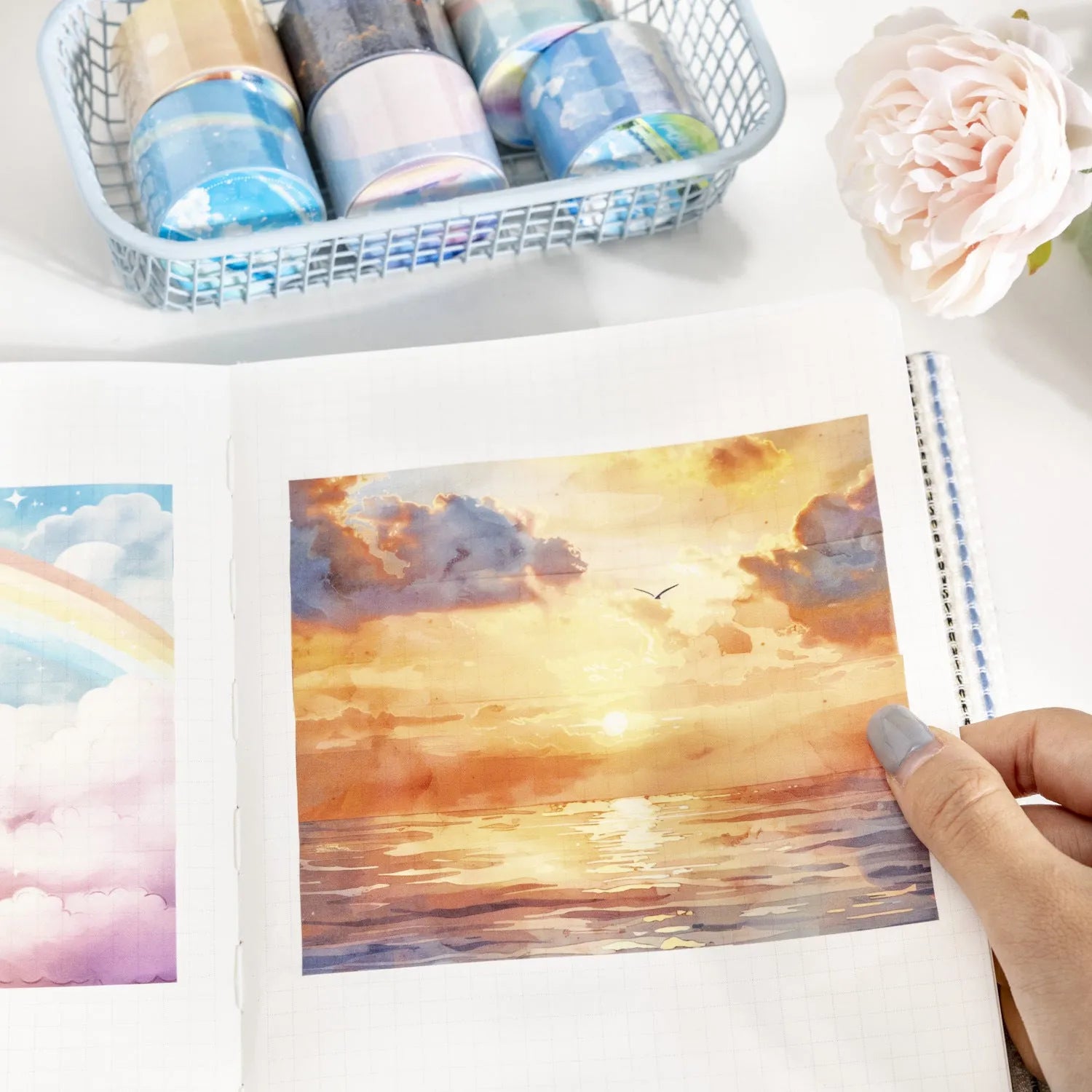 Roll of Japanese paper decorative tape with sky theme patterns including clouds, sun, moon, and nebula.