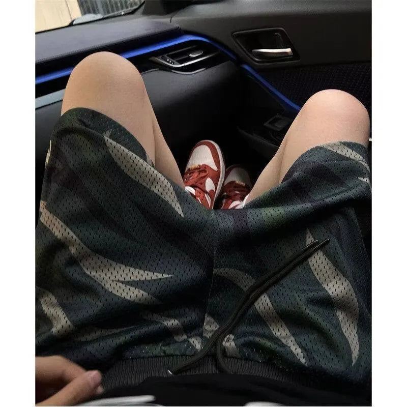 Men's camouflage pattern mesh shorts with straight leg cut