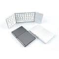 Black and silver mini tri-fold Bluetooth keyboard shown unfolded, displaying its slim profile and compact key layout.