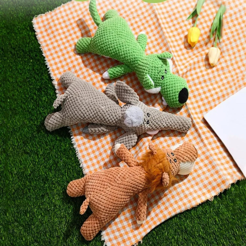 Green plush dog chew toy shaped like an animal with a textured corn kernel surface.