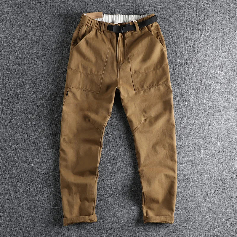 Men's khaki cotton work trousers with N I buckle belt showing three-dimensional cutting detail
