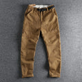 Men's khaki cotton work trousers with N I buckle belt showing three-dimensional cutting detail