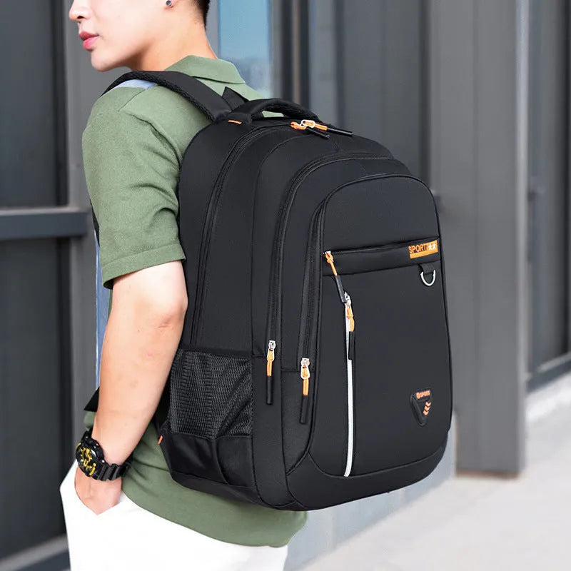 Men's large black Oxford cloth schoolbag with air pillow shoulder straps and splicing design detail.