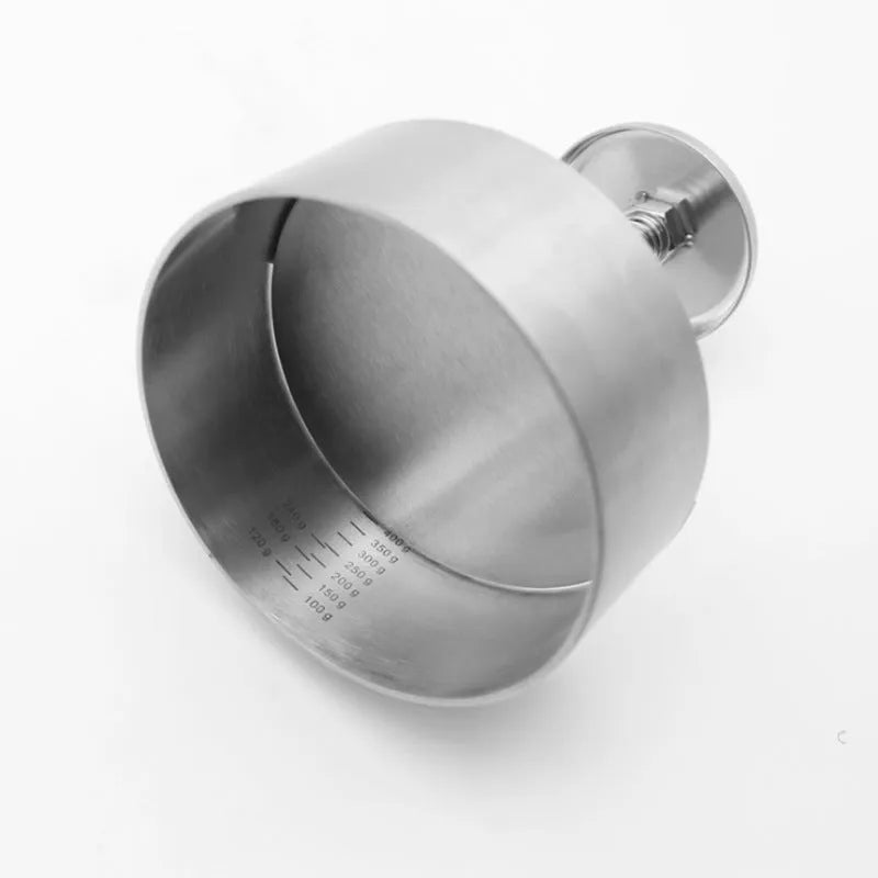 Silver stainless steel patty mould with 14cm diameter on a kitchen counter
