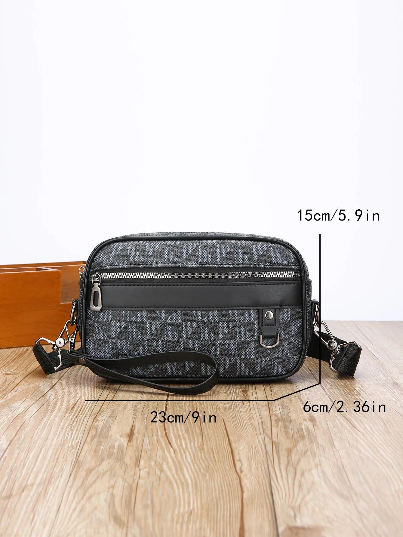 Men's black casual shoulder messenger bag with geometric pattern, shown with handheld top handle and adjustable shoulder strap.