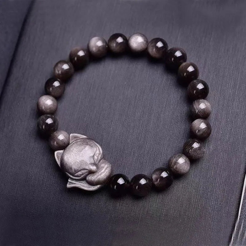 Obsidian fox single ring bracelet showing detailed fox carving on 8mm polished black stone band
