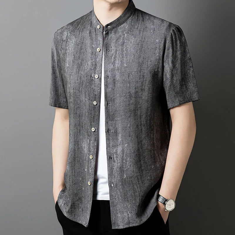 Men's loose grey linen shirt with stand collar, cardigan style, on a hanger.