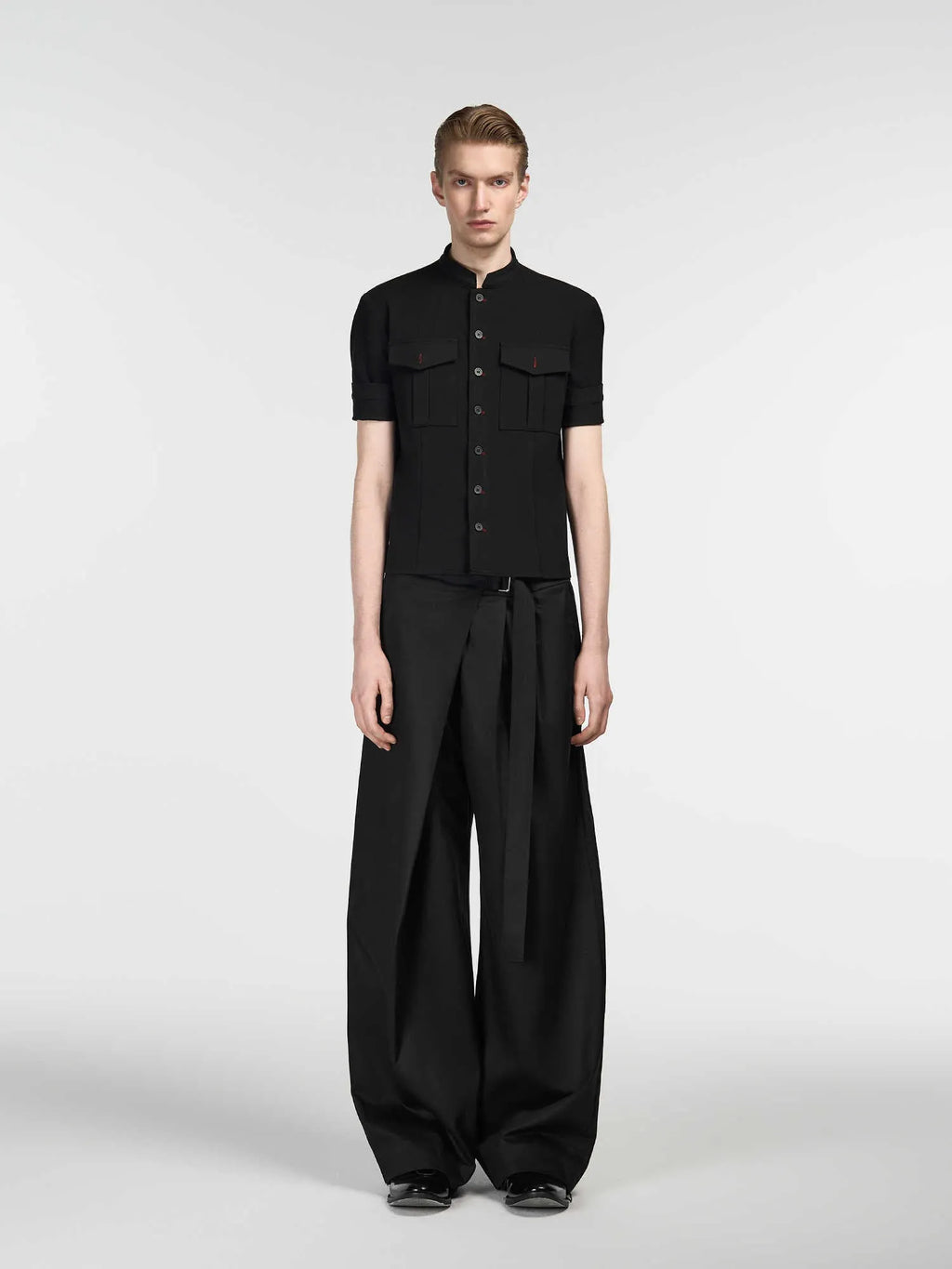 Black straight-leg trousers made from Tencel and cotton blend with a single pleat and adjustable waistband.