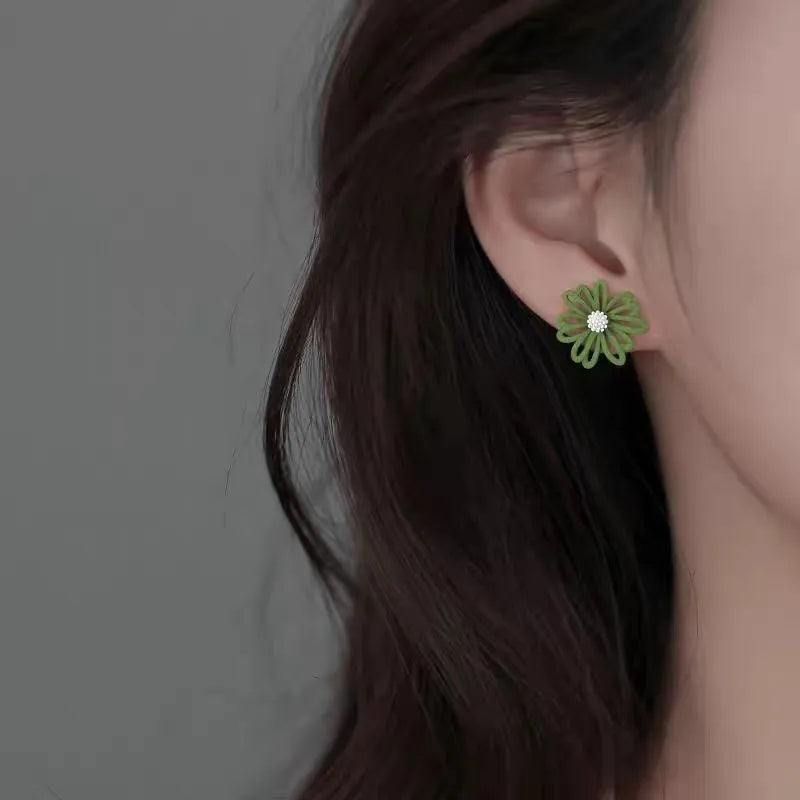 Cartoon flower stud earrings in alloy with two-tone blue and orange, white and green, or yellow and white colour combinations