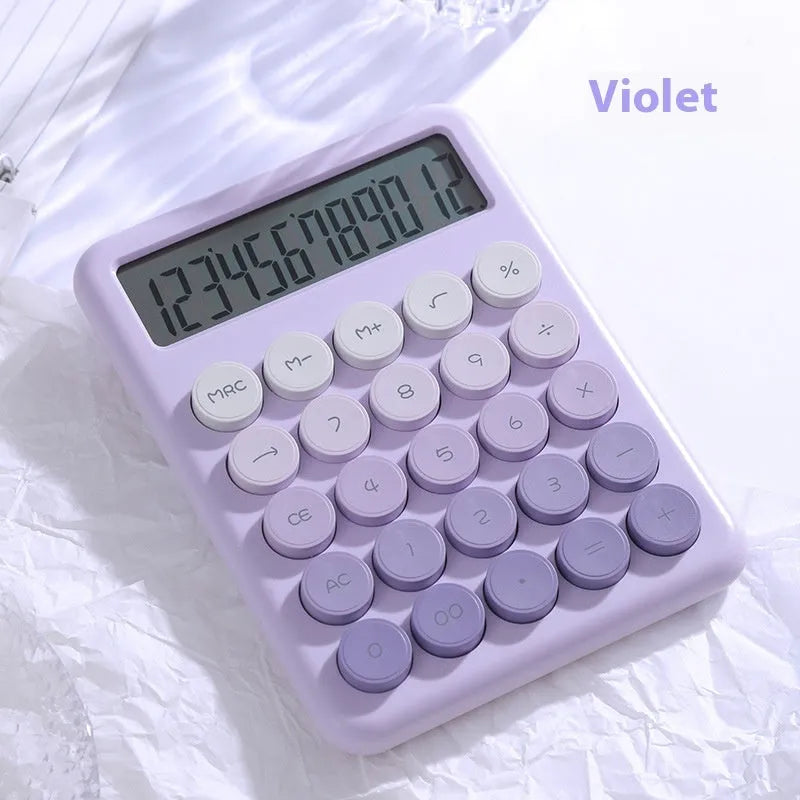Gradient colour desk calculator in violet, cherry blossom pink, blue, and mint green finishes on a desk.