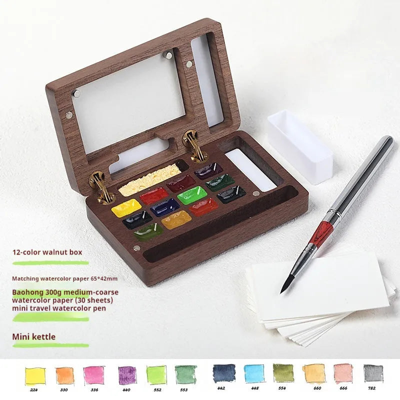 Mini walnut wooden watercolour paint box open to show pigment suit inside