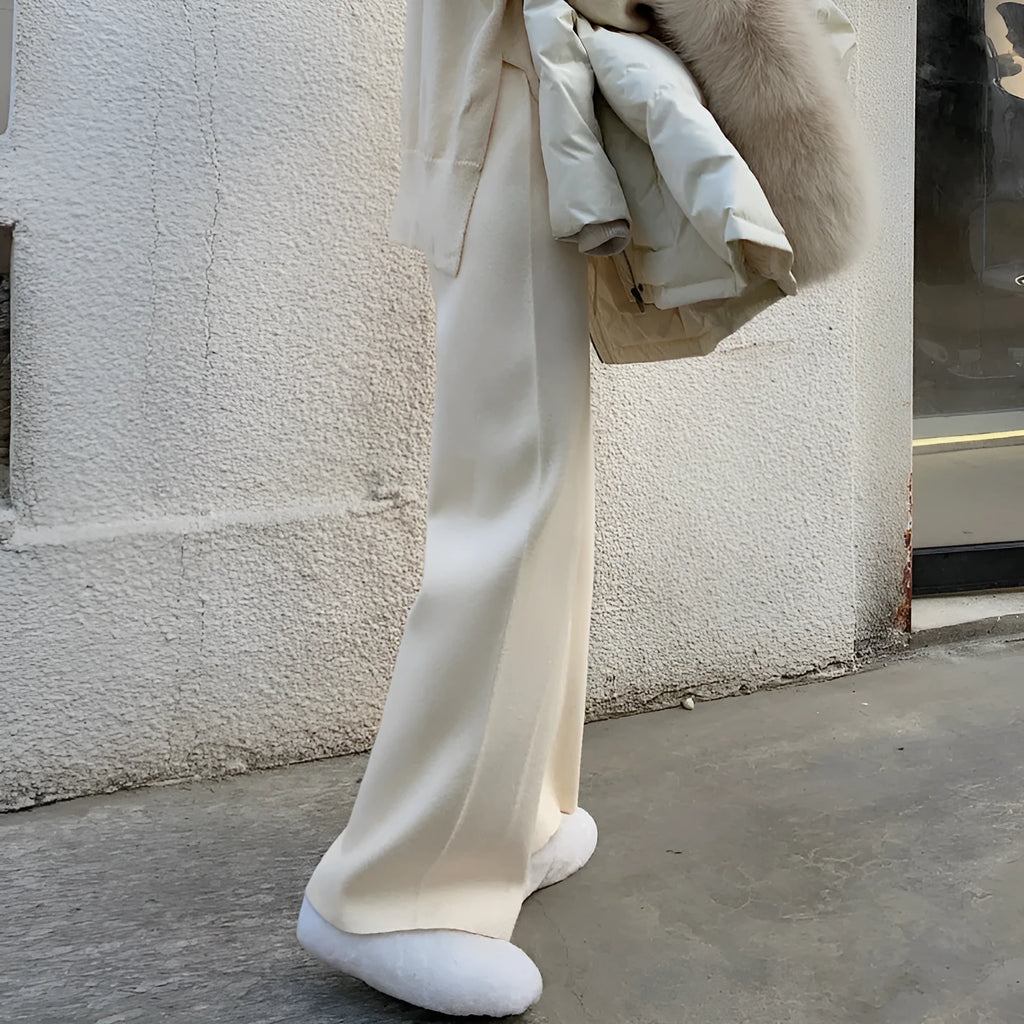 Women's cream white knitted wide-leg high-waist trousers laid flat, showing long straight-leg mopping style.