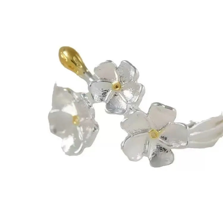 Open silver-tone ring with a 3D jasmine flower and multiple small flowers on the band.