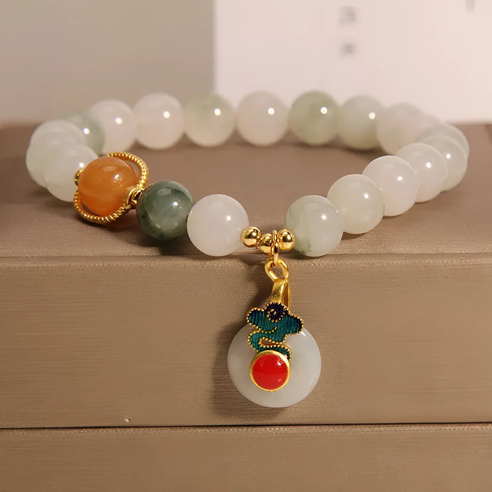 Women's ice jade crystal bracelet with a pearl detail and traditional Chinese jade buckle.