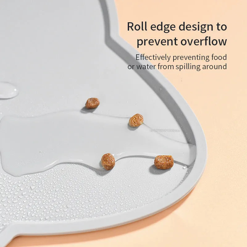 Blue waterproof silicone pet feeding mat for dog or cat bowls on a wooden floor.
