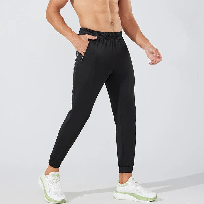 Men's black polyester running trousers with mid waist and full leg length for exercise.