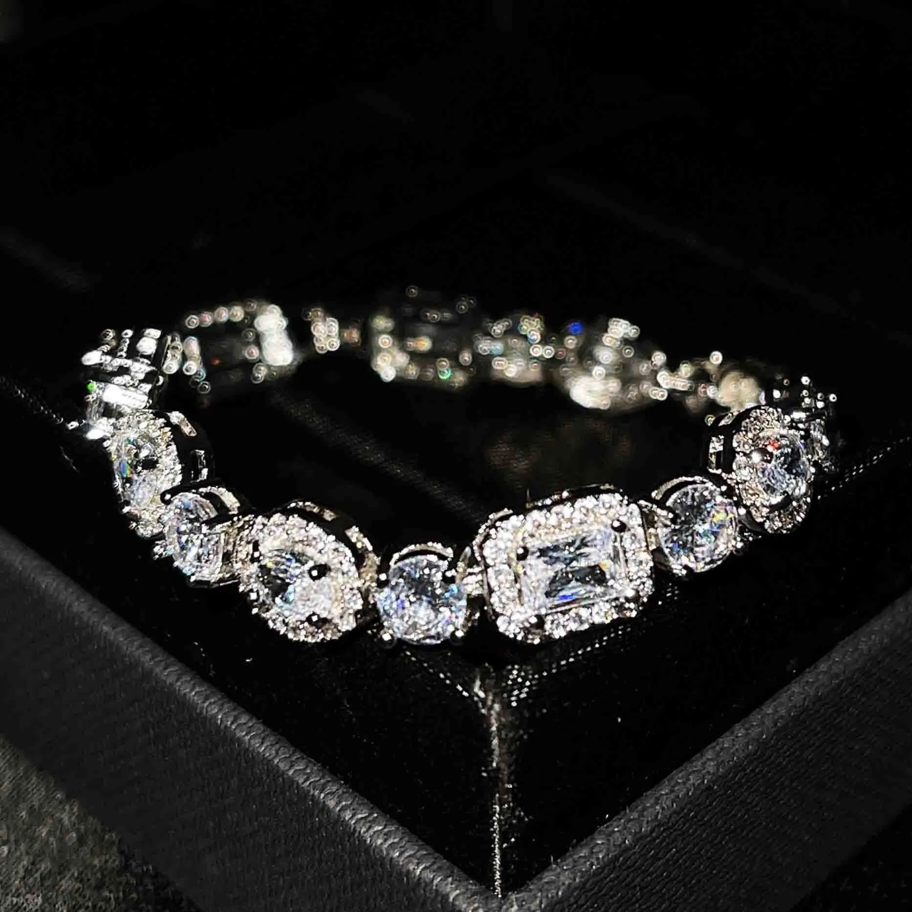 Women's sterling silver-plated bracelet with zircon stones on a geometry-patterned chain.