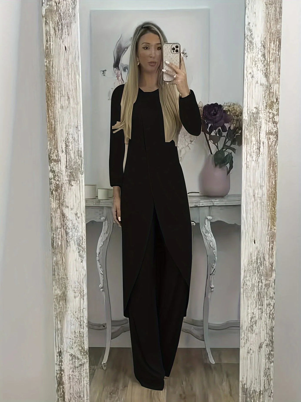 Man wearing a black long sleeve round neck top and matching loose trousers from a casual two-piece set.