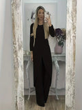 Man wearing a black long sleeve round neck top and matching loose trousers from a casual two-piece set.