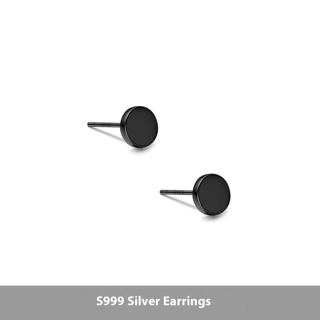 A pair of small, round, flat sterling silver stud earrings for cartilage piercing on a plain background.