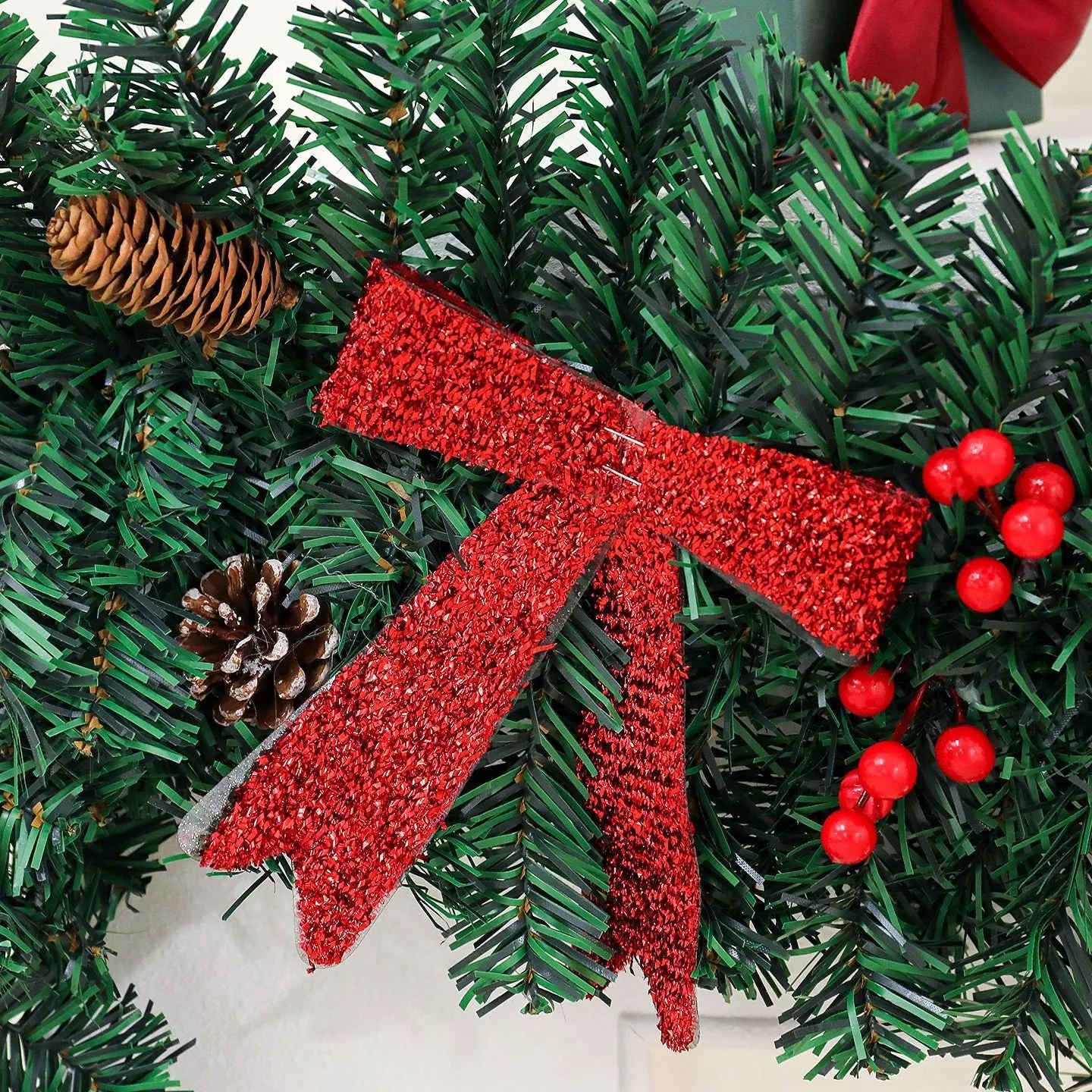 European style Christmas rattan decoration with pine cone bow design, available with coloured or warm white lighting options