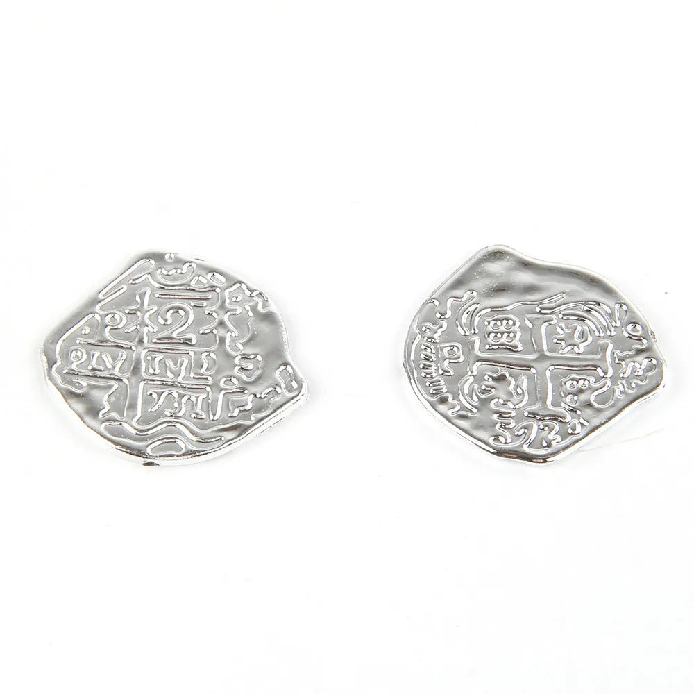 Close-up of gold, silver, and bronze plastic replica Roman pirate coins from a 100-piece set.