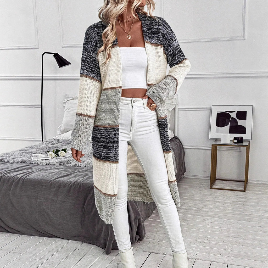 Grey loose-fit long knitted cardigan for women on a hanger, showing long sleeves and a stripe or plaid pattern.