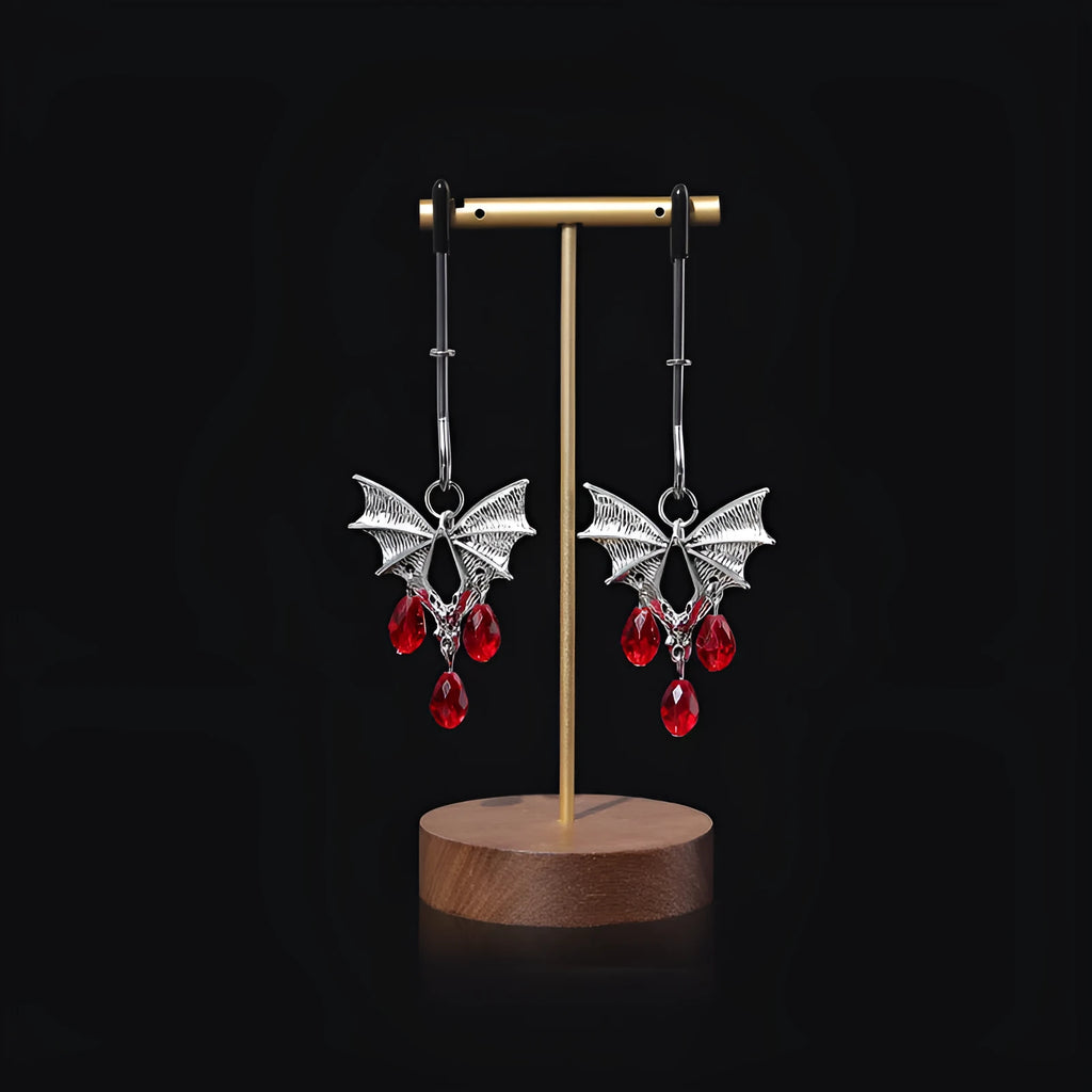 Silver bat-shaped nipple clamp with ruby detail and adjustable tension mechanism