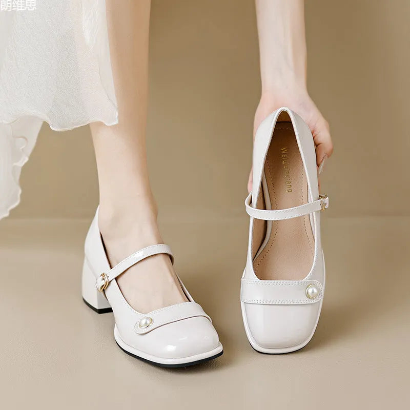 French-style women's chunky heel pumps with patent leather upper and buckle fastening