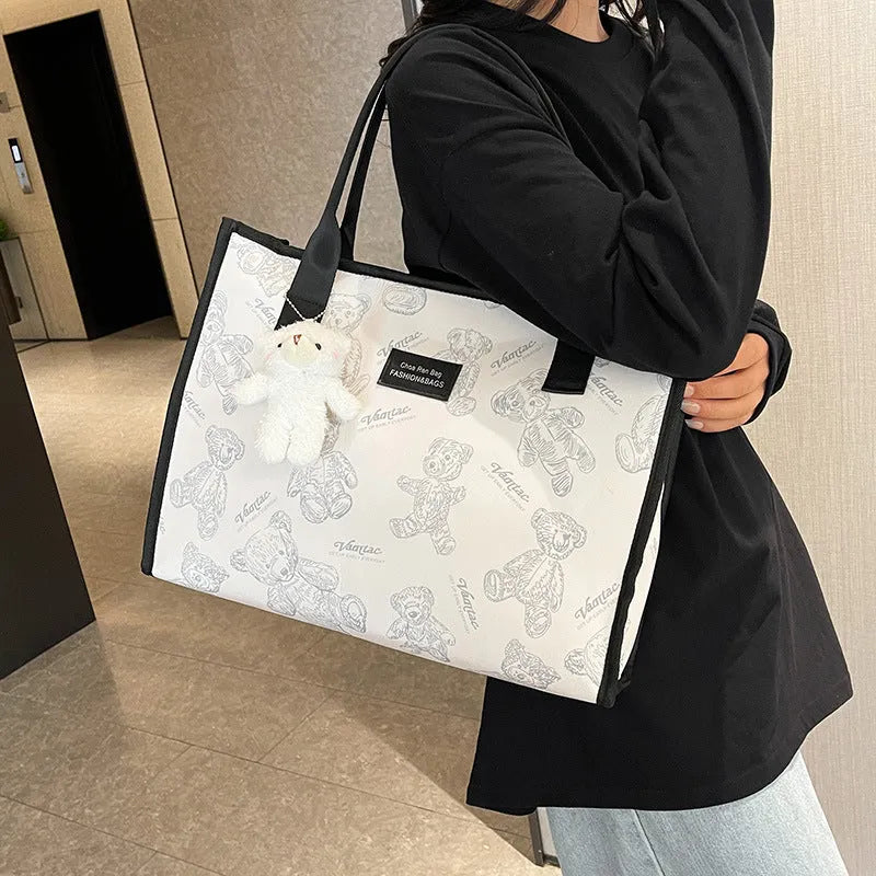 Women's black and white printed canvas tote bag with rhombus pattern showing large capacity and shoulder strap