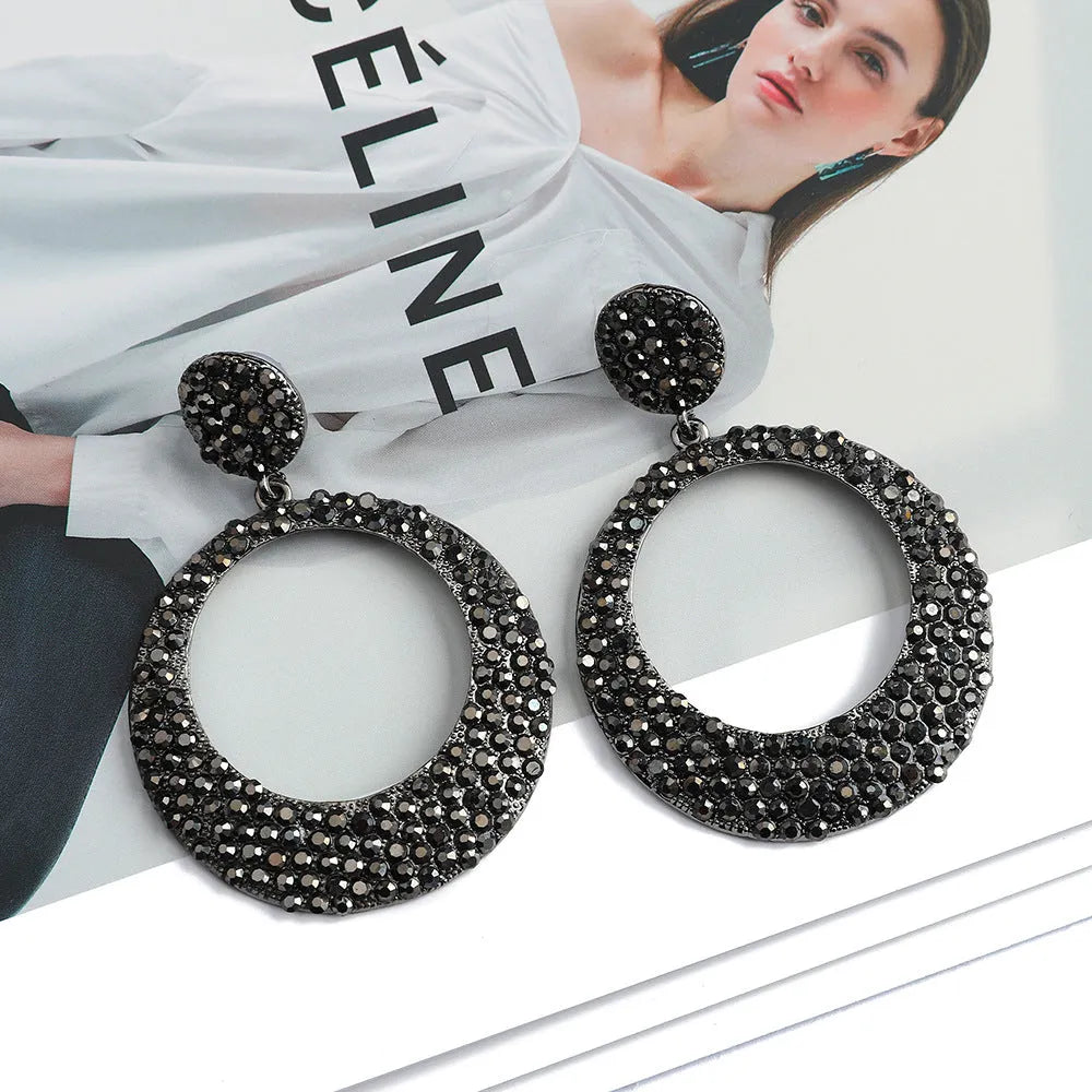 Colourful alloy metal earrings with large round diamond-look pendants in cartoon style
