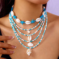 Blue and coloured women's summer necklace set with starfish, shell, and conch bead pendants on beaded chains