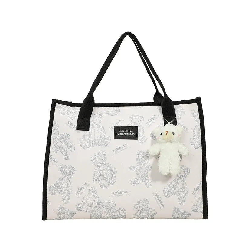Women's black and white printed canvas tote bag with rhombus pattern showing large capacity and shoulder strap