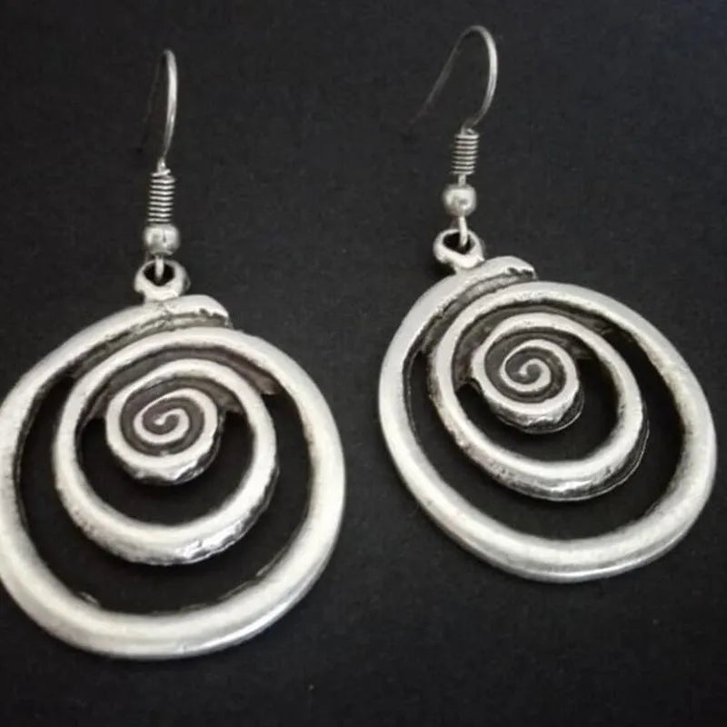Silver alloy geometric spiral earrings with a distressed finish, measuring 2.6cm by 5cm.