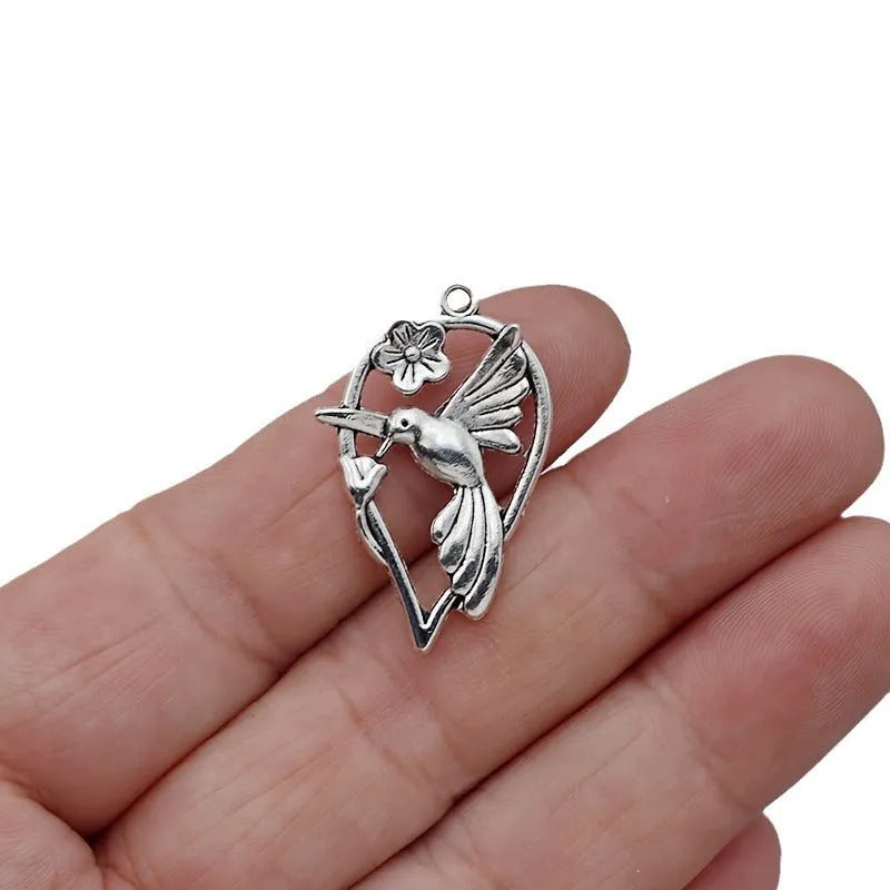 Alloy magpie bird pendant charm with electroplated finish on a white background.